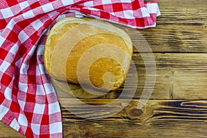 Homemade loaf of bread on wooden table freshly baked in an electric bread maker. Homemade baking