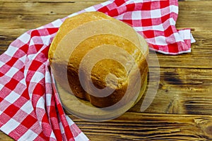 Homemade loaf of bread on wooden table freshly baked in an electric bread maker. Homemade baking