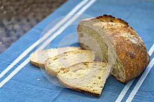 Homemade loaf and slices of freshly baked artisan sourdough bread