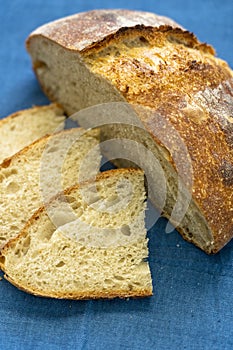 Homemade loaf and slices of freshly baked artisan sourdough bread