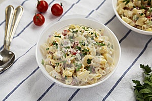 Homemade Macaroni Salad in white bowls, side view