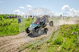 Homemade machine built with tuning rally buggy rides with the driver and co-driver at high speed past the spectators along the du