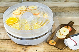 Homemade machine to dehydrate food with orange and apple slices