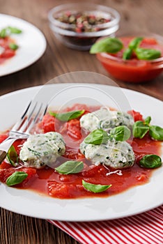 Homemade malfatti with tomato sauce