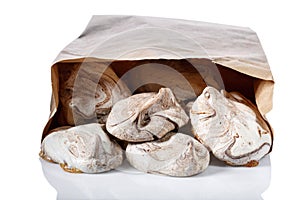 Homemade marble chocolate meringue cookies in paper bag