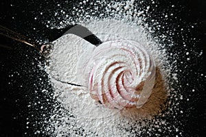 Homemade marshmallow on a dark background.