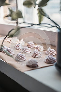 Homemade marshmallow on parchment paper dries in the sun on a windowsill. Homemade sweets, comfort, handmade