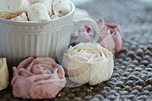 Homemade marshmallows around grey cup with cocoa or hot chocolate over the top