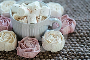 Homemade marshmallows around grey cup with cocoa or hot chocolate over the top