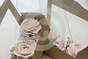 Homemade marshmallows. Zephyr flowers in a paper gift box. Close-up