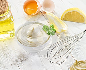 Homemade mayonnaise with ingredients and herbs