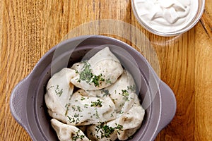 Homemade Meat Dumplings with cour cream - russian pelmeni in a plate