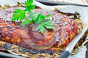 Homemade meatloaf with ketchup and parsley