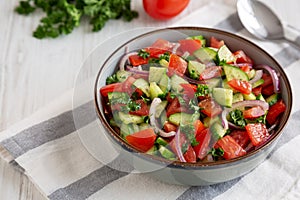 Homemade Mediterranean Cucumber Tomato Salad in a Bowl, side view. Copy space