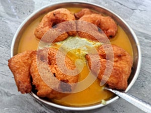 Homemade mendu vada sambhar with chutney in plate on kitchen floor