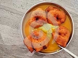 Homemade mendu vada sambhar with chutney in plate on kitchen floor