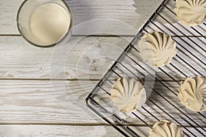 Homemade meringue and milk on a wooden table and art background. Breakfast. Close.