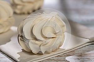 Homemade meringue and milk on a wooden table and art background. Breakfast. Close.