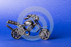 Toy model of a sports motorcycle on a blue background