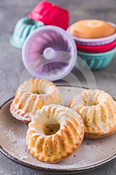 Homemade mini bundt cakes on a playte and colorful silicone cake molds