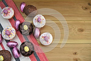 Homemade mini cakes with chocolate Easter eggs for decoration and space