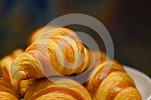 Homemade mini croissants on white plate in buffet line. Fresh Baked Buttery Croissants photo