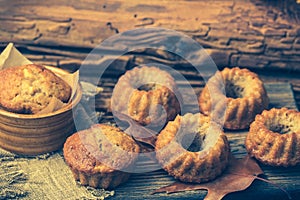Homemade mini guglhupf, bundt cakes, muffins, on rustic wooden background