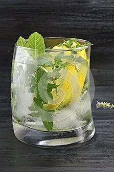Homemade mojito in a glass on against dark background