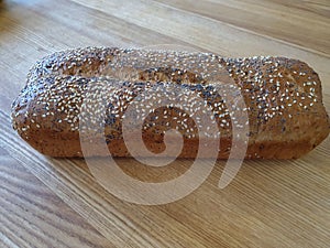 Homemade, molded, browned, crunchy bread sprinkled with poppy seeds and white sesame seeds. A natural, fresh, delicious