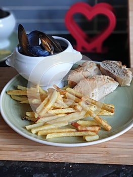 Homemade moules  frites,  chips, French fries, ciabatta bread  and mussels cooked in cream, garlic and white wine