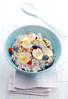 Homemade muesli topped with fruit and buts