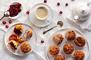 Homemade muffins with cranberry filling, on light background.