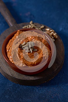 Homemade muhammara in a brown earthenware bowl