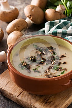 Homemade mushroom soup in bowl on wood
