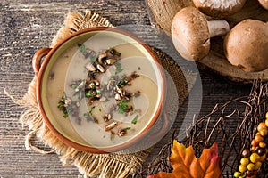 Homemade mushroom soup on wood.