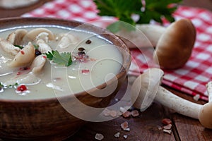 Homemade mushroom soup in wooden bowl