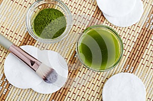 Homemade natural face toner infusion, tincture with matcha powder. Diy green tea cosmetics recipe. Top view