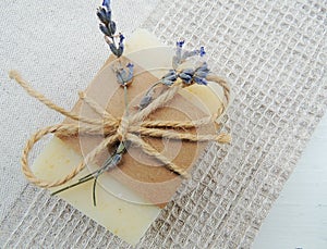 Homemade natural spa lavender soap on handmade waffle linen towel background. Soap making.