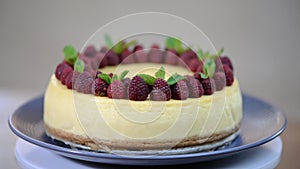 Homemade New York cheesecake on a cake stand decorated with fresh berries