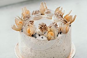 Homemade nut cake with physalis. Delicious and delicate homemade cake. Cake with walnuts and berries