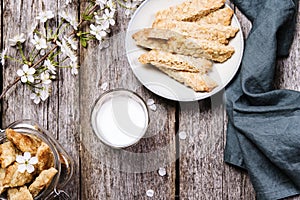 Homemade oatmeal cookies in a bowl and glass jar and cup of milk