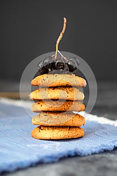 Homemade oatmeal cookies with raisins on a dark background.