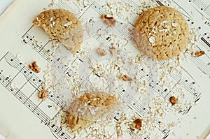 Homemade oatmeal cookies with walnut on vintage music sheet