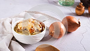 Homemade onion soup with croutons and cheese in a bowl on the table web banner