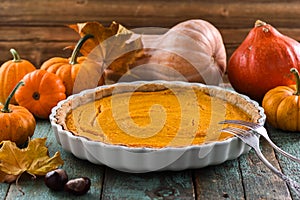 Homemade open pumpkin pie for Thanksgiving dinner served with de