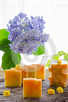 Homemade orange and dandelion herbal soap photo