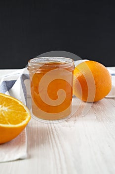 Homemade orange jam in glass jar, side view. Close-up