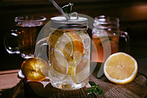 Homemade orange lime lenon lemonade on the dark rustic background photo