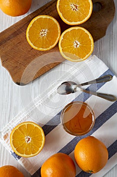 Homemade orange marmelade over white wooden surface, overhead view. Flat lay, top view, from above