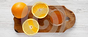 Homemade orange marmelade on rustic wooden board over white wooden surface, top view. Flat lay, overhead, from above